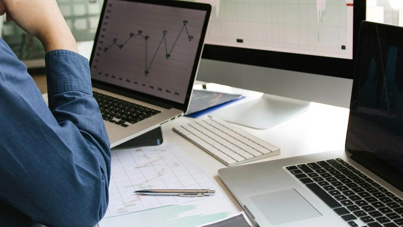 7 Effective Website Optimization Strategies in 2024 Investors are using laptops entering investment websites stocks market and partners