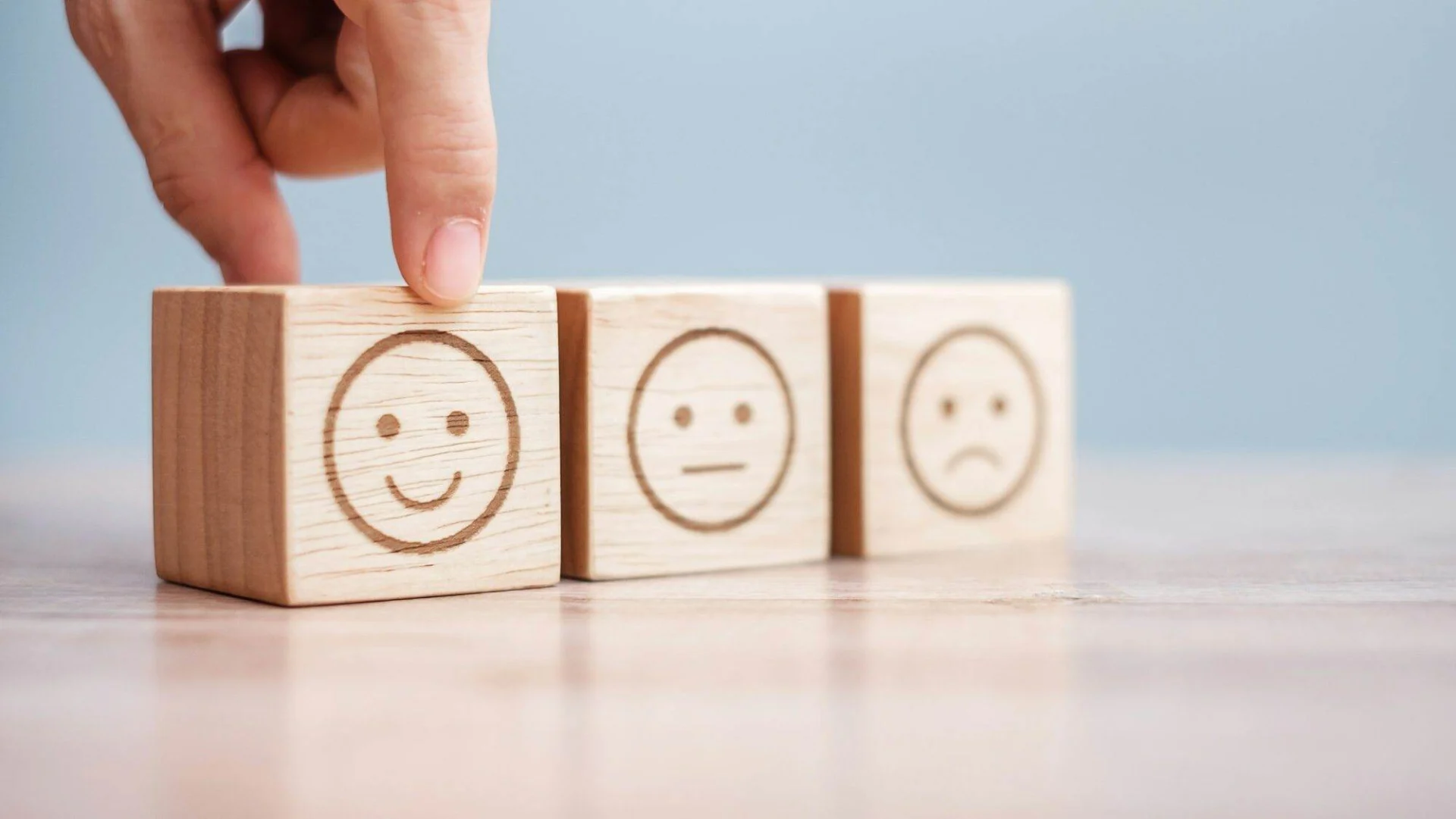 A Beginners Guide to Choosing the Right Web Hosting Provider for Your Website Man hand holding emotion face block. review, satisfaction and feedback concept