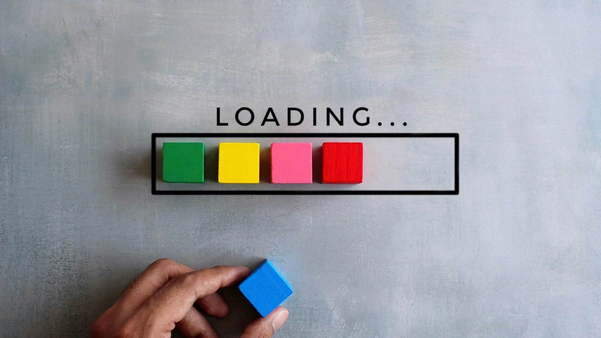 A Beginners Guide to Choosing the Right Web Hosting Provider for Your Website Top view image of loading bar with colorful wooden blocks on concrete floor.